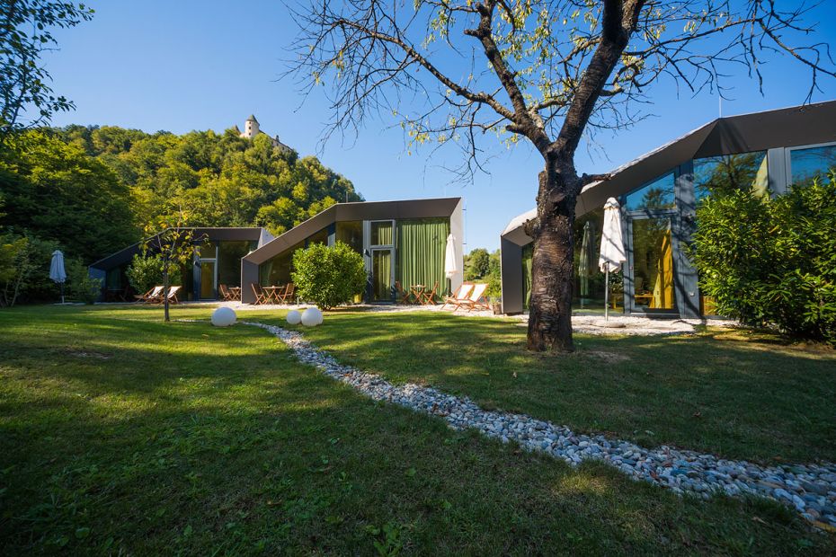 Image of Ortenia apartment in the heart of nature. A monastery is visible on a green hill in the distance.